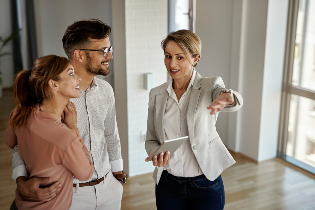 a happy couple seeking professional help to determine the rent of their residential property.